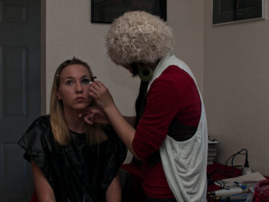 Makeup artist Stefanie applies eye makeup to model Anne during preparations for the Octopus Project.