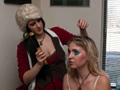 Makeup artist Stefanie styles model Anne’s hair with a curling iron during the Octopus Project photo shoot.