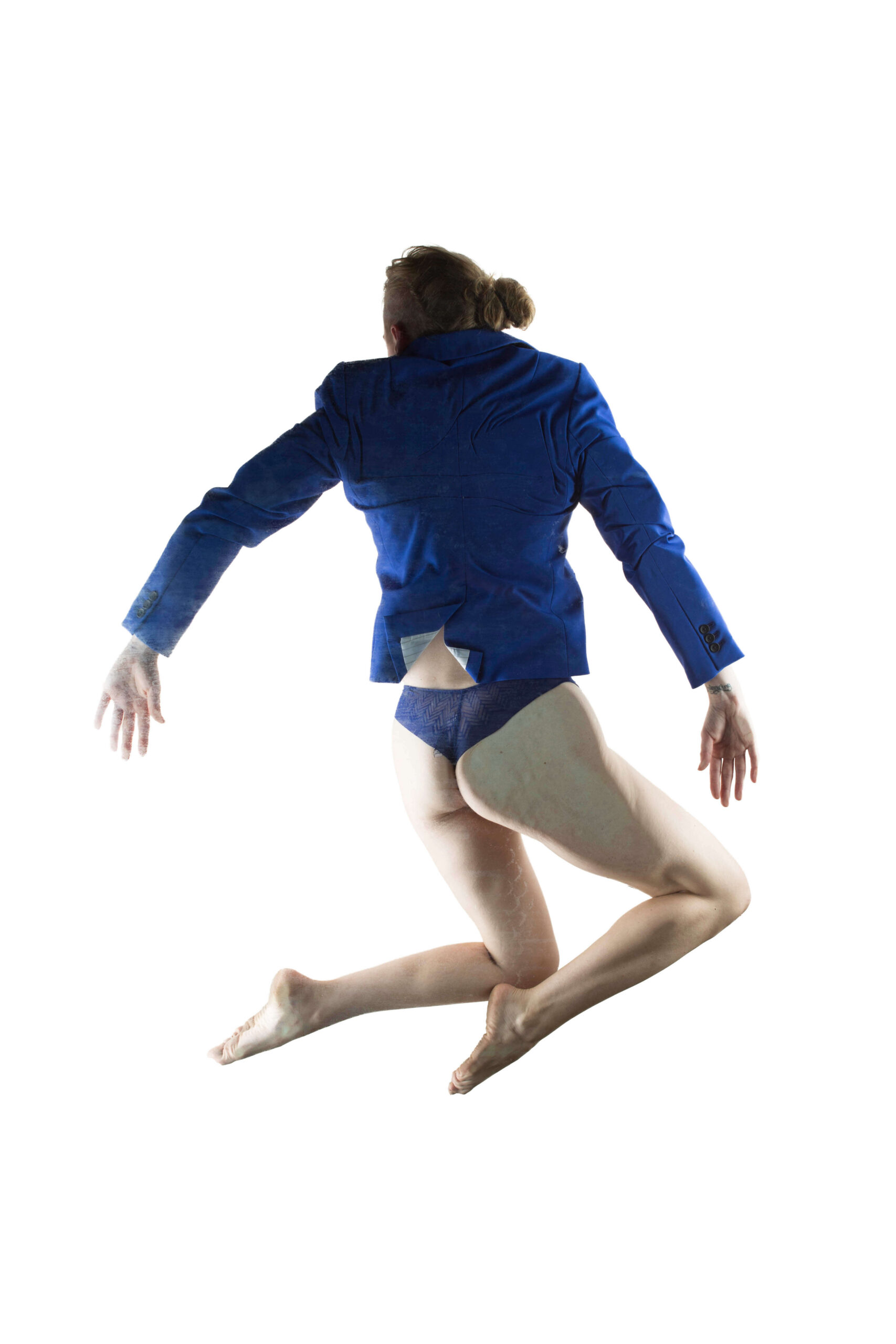 Hippy Researcher poses suspended in midair with her back to the camera, wearing a royal blue blazer and matching blue underwear. Her bent legs and outstretched arms create a dynamic silhouette against a brilliant white background.